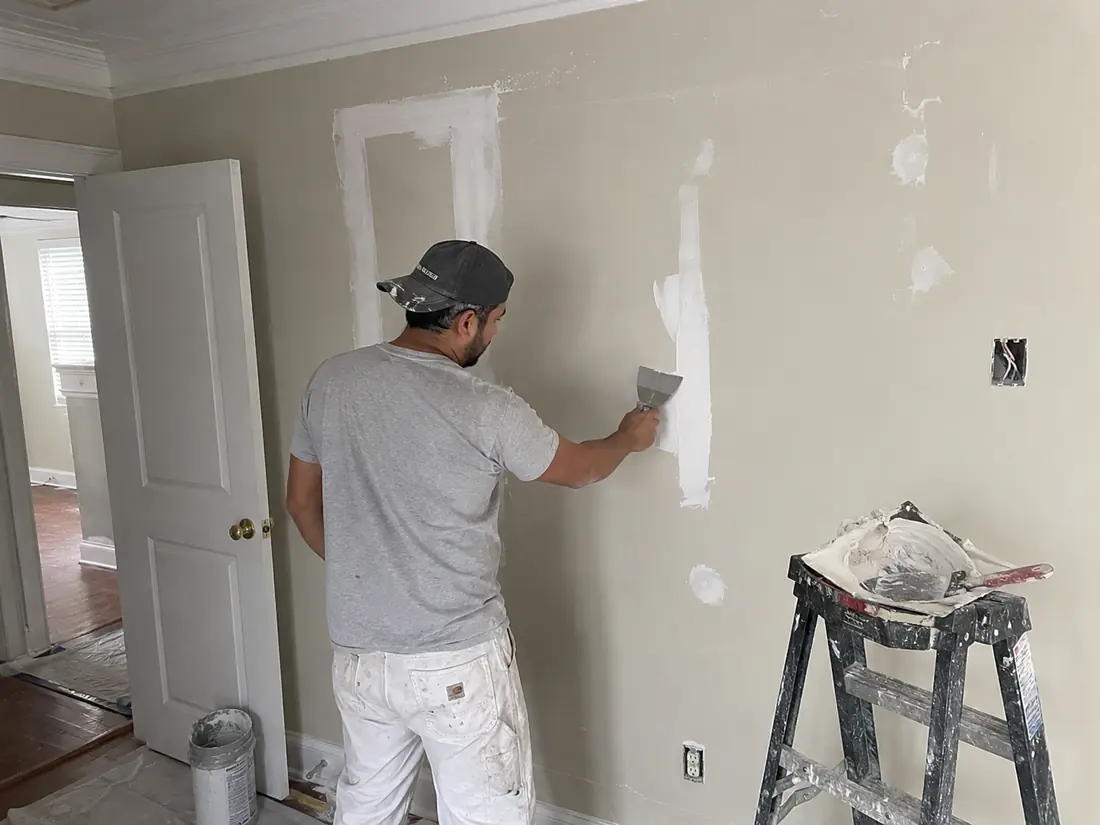 Drywall repair patch being feathered in a Shreveport home