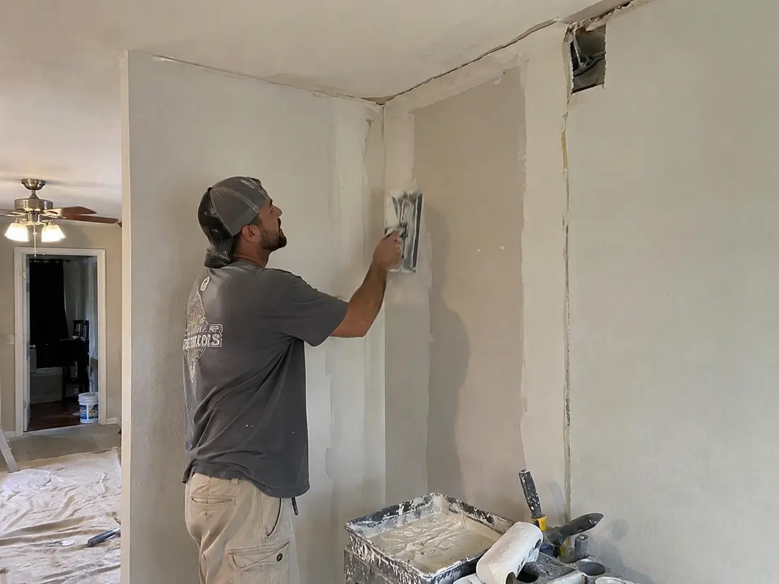 Water-damaged drywall cut back to sound material